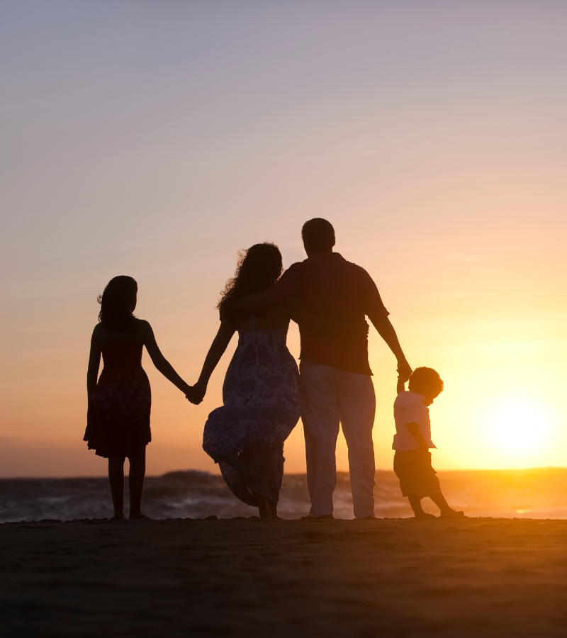 family on the beach at sunset
