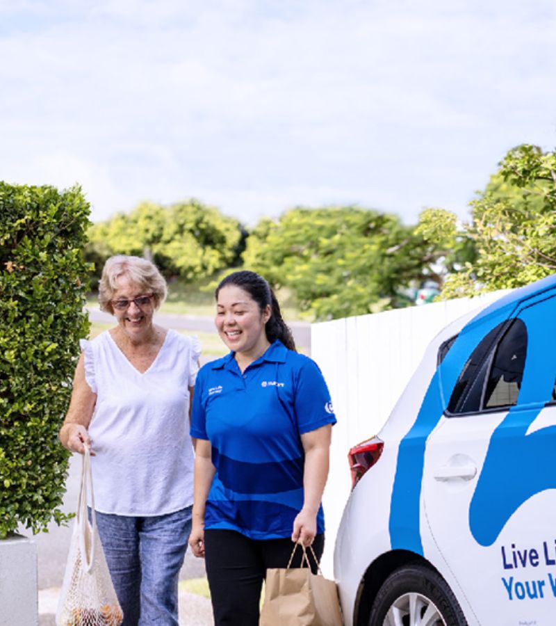 bluecare employee carry groceries from car