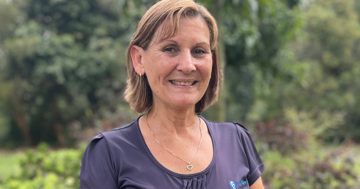 A woman smiles at the camera