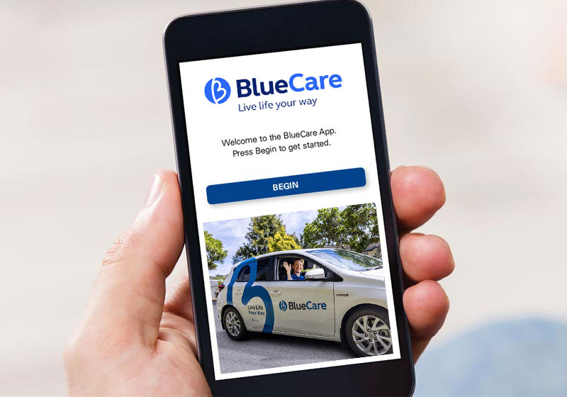 someone holding phone with bluecare app