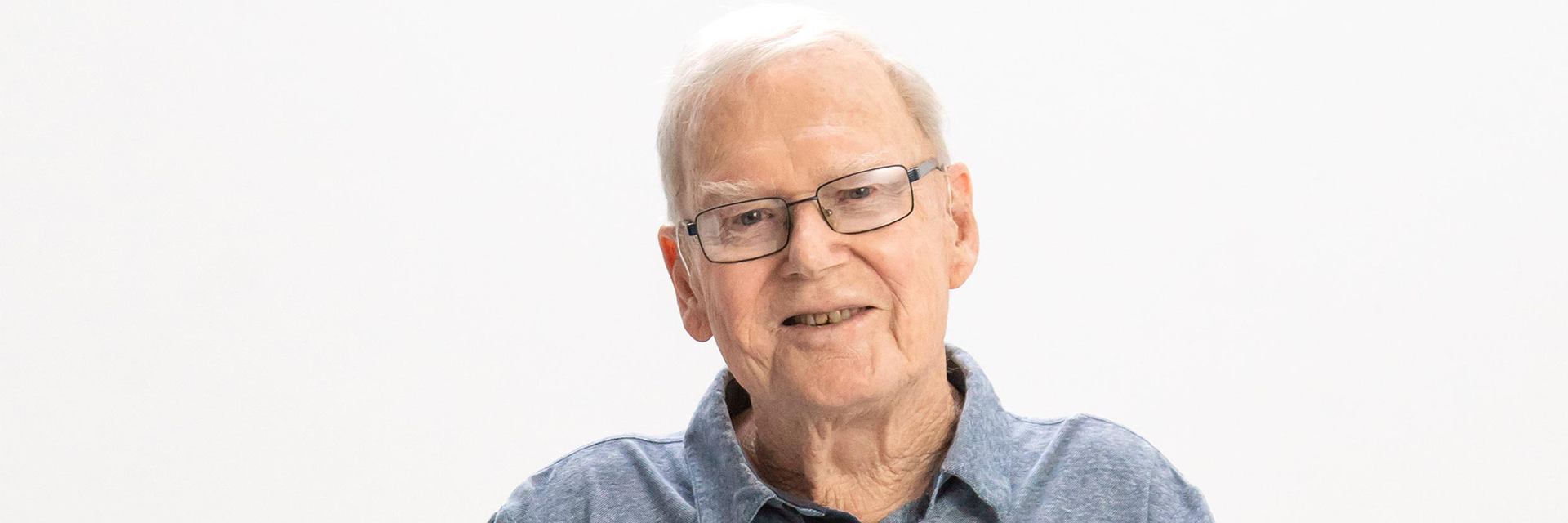 Blue Care client bob smiling at camera on a white background