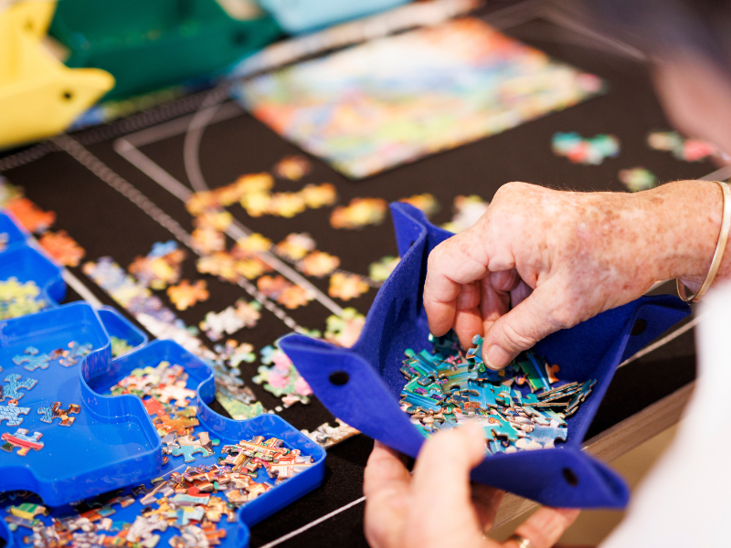 hands playing a puzzle