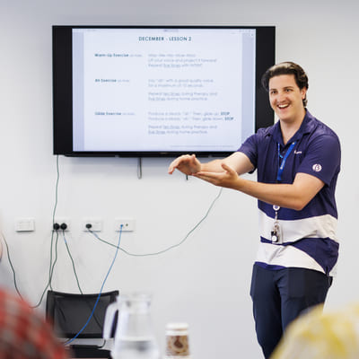 A BlueCare employee presenting something