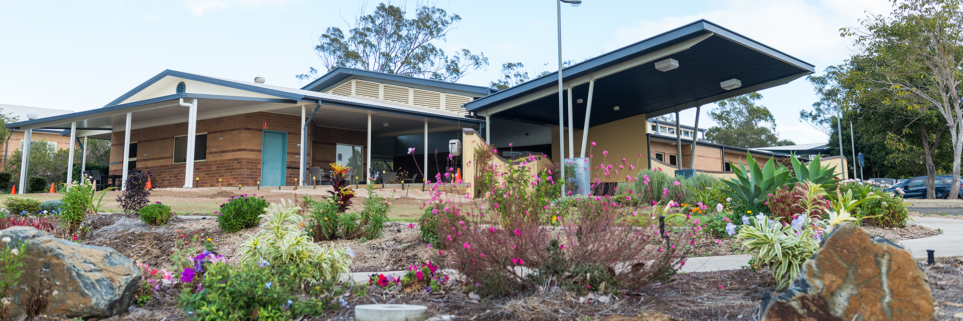 Pretty, colourful flowers adorn the garden beds on the approach to Blue Care Gladstone Edenvale Aged Care Facility.