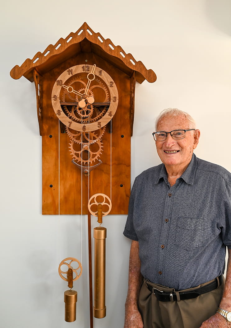 Eric standing next to clock