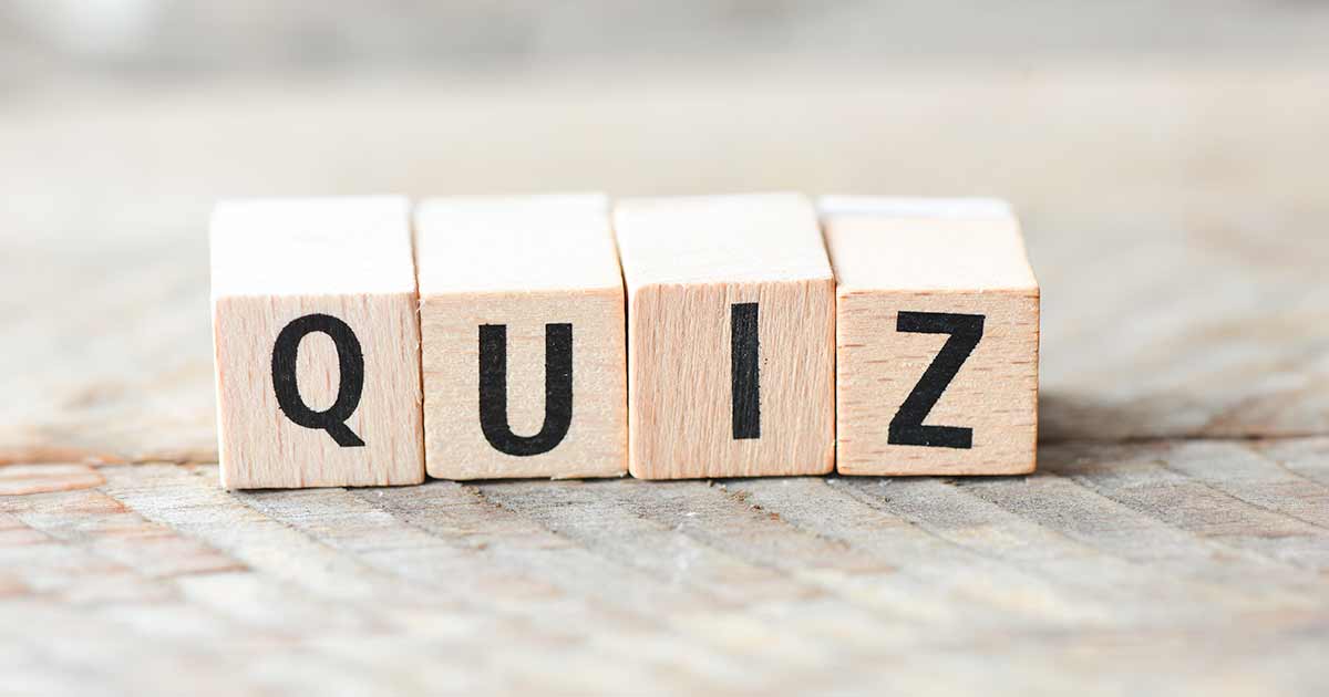 Four wooden blocks spelling out the word QUIZ sitting on a table