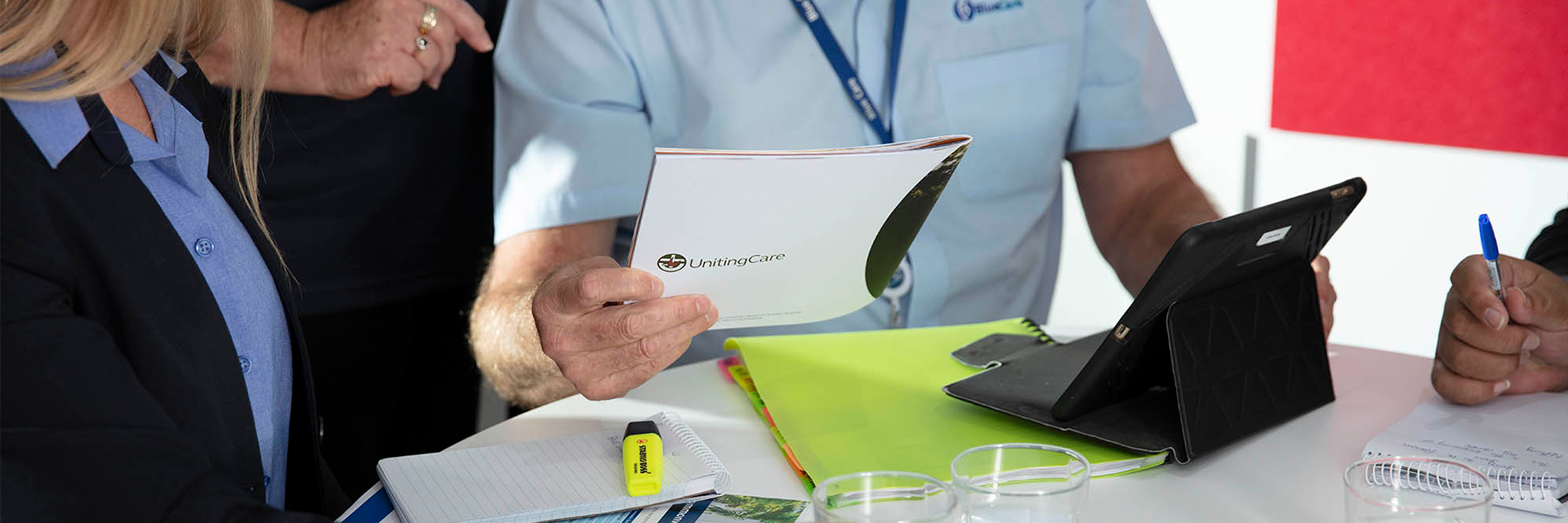 Blue Care employees review documents in an office