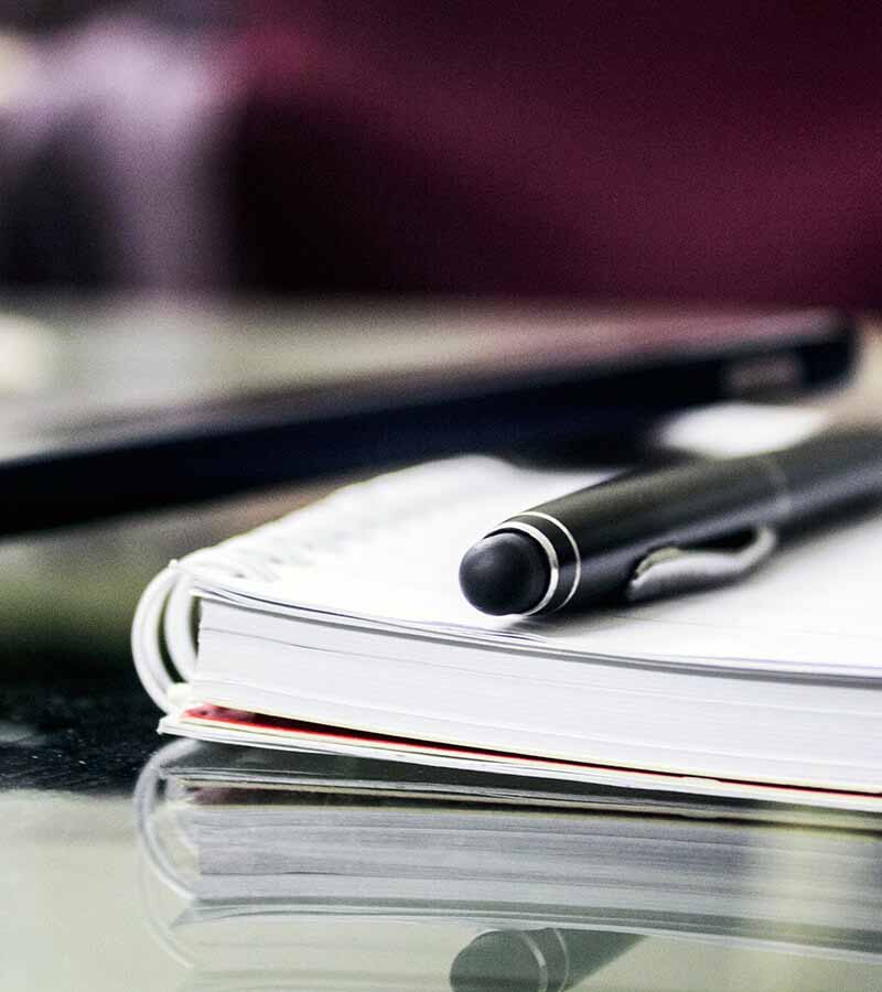 Close up of pen and book on table