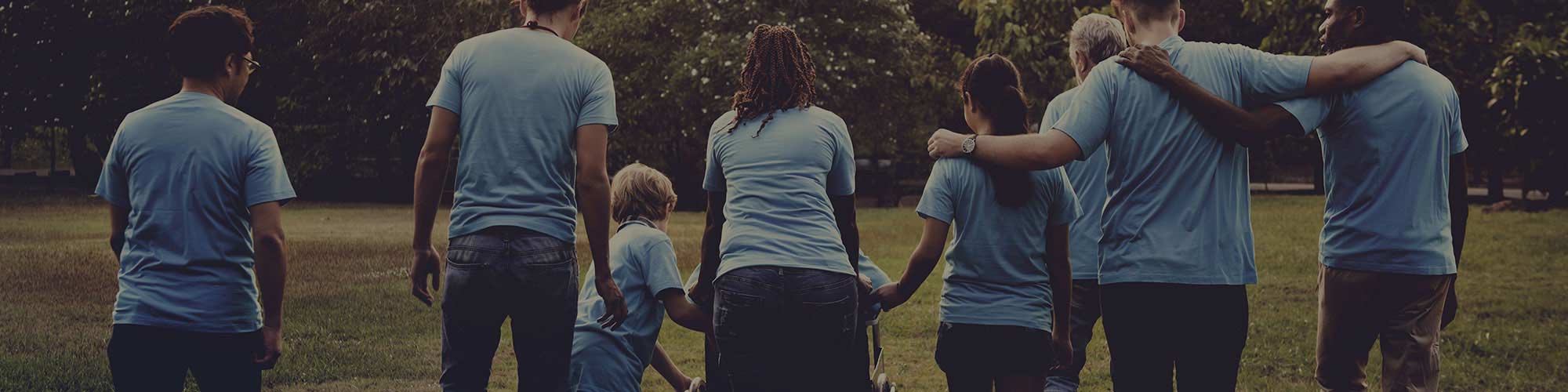 multiple volunteers embracing outdoors