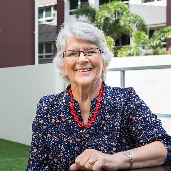 elderly lady standing outside smiling