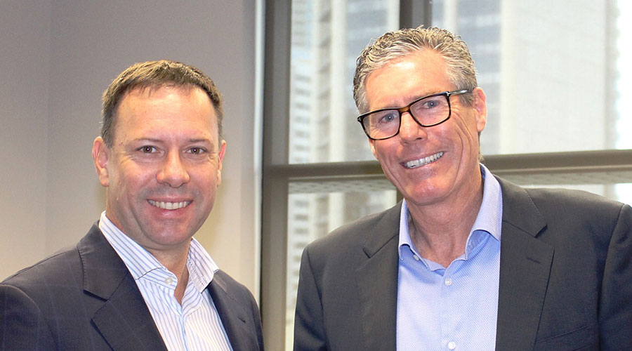 two men smiling in the office environment