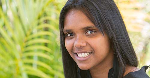 young indigenous woman outdoors smiling