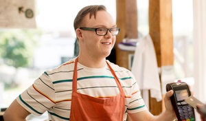 happy disabled man working at café smiling