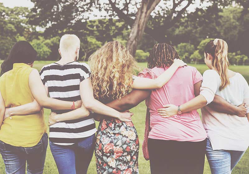 Young girl playing outside with mother
