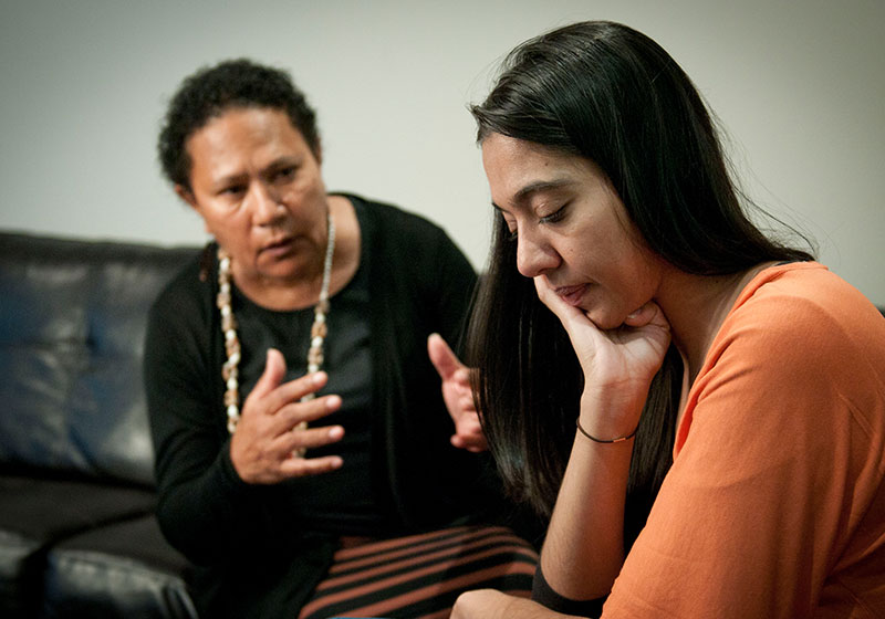 concerned parent talking to addict young adult