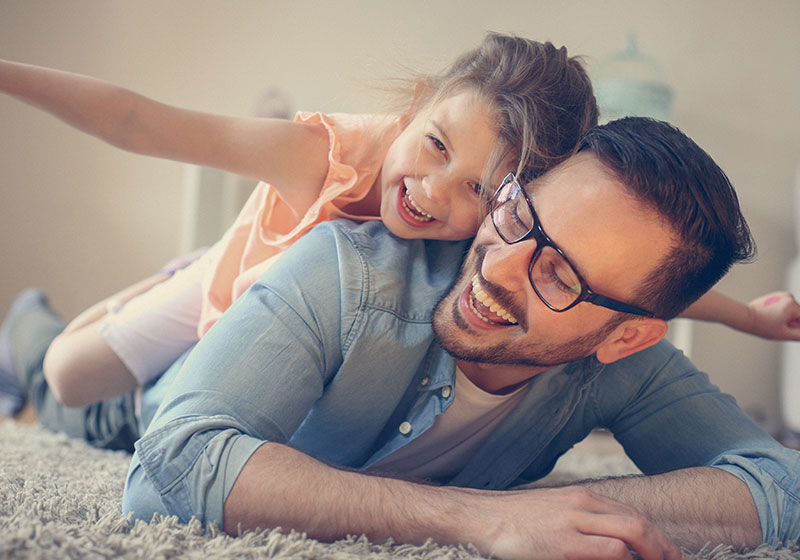 Young girl playing outside with mother