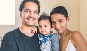 happy family with small child smiling at camera
