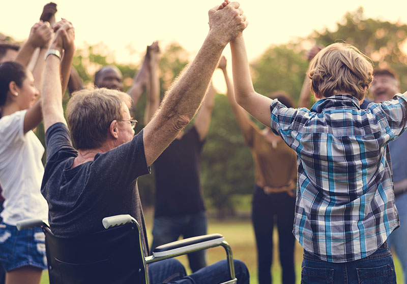 group of people holding hands outside