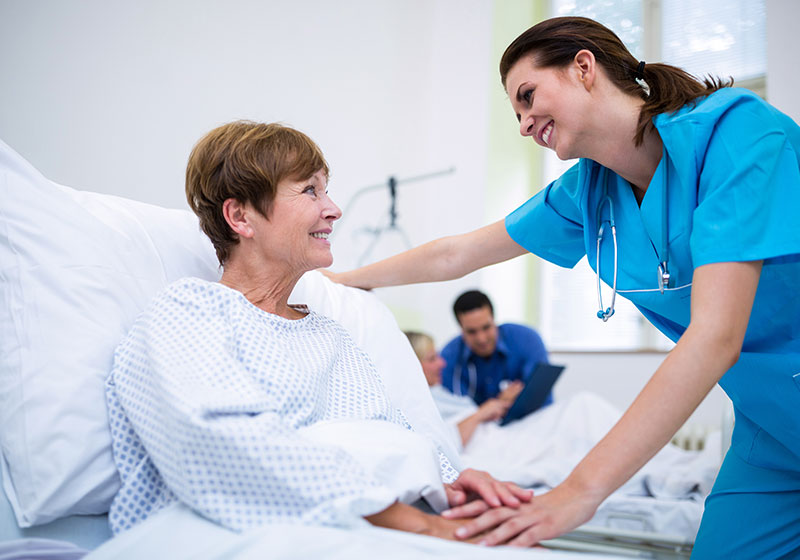 woman doctor comforting older female patient