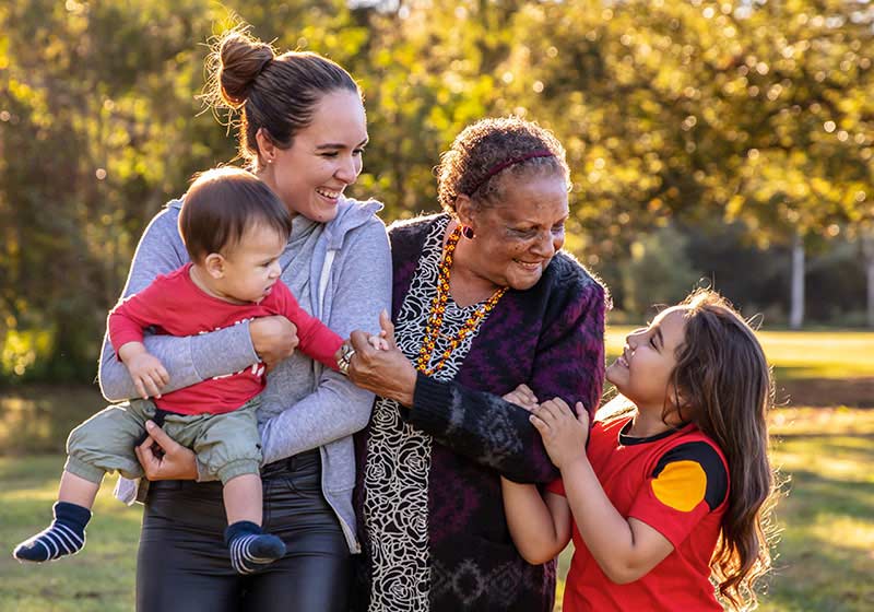 Young girl playing outside with mother