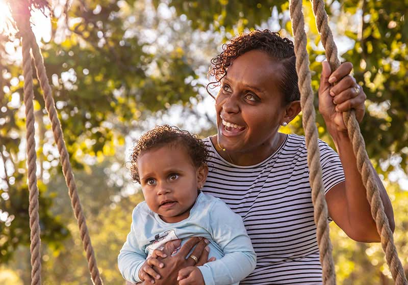 abogirinal woman with her child swinging