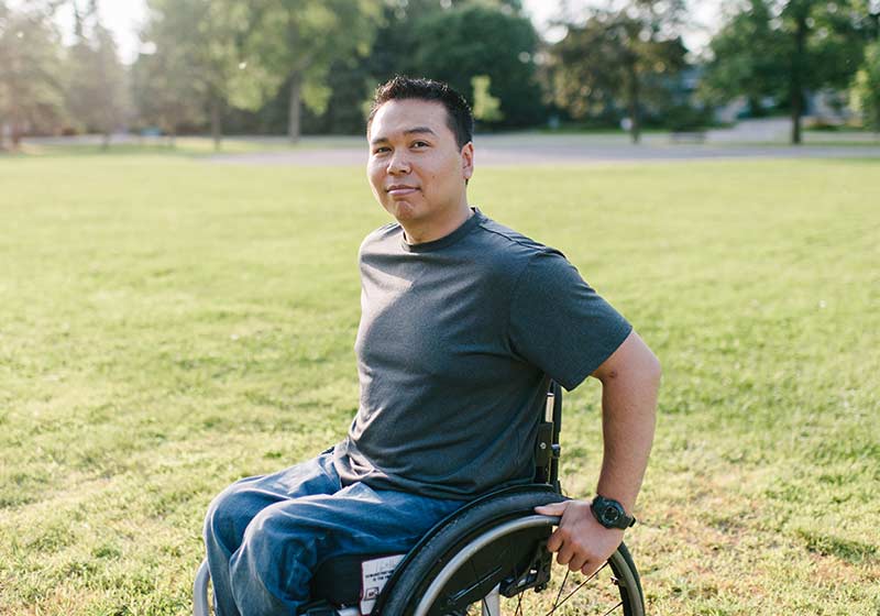 man in wheelchair in park