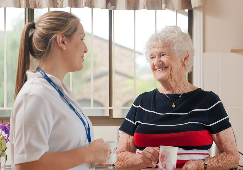 Carer and client enjoying a cup of tea in the client's home