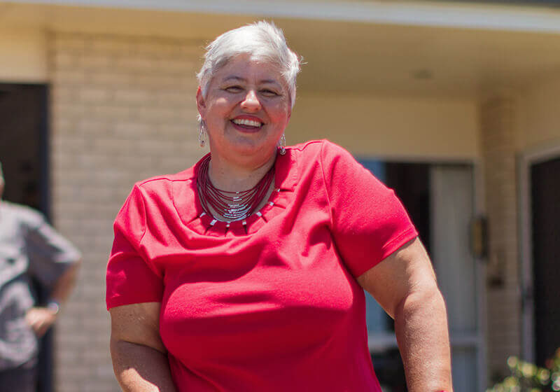 Woman on crutches standing in driveway