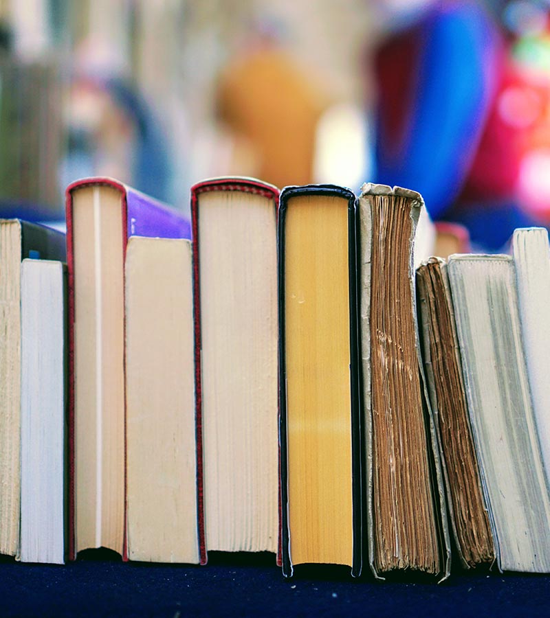 Image of the base of a row of books on a table