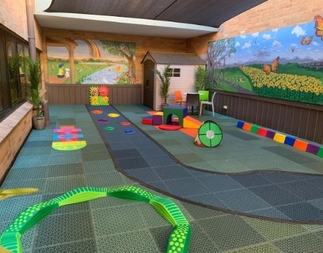 A playground with recycled plastic floor mats and activities